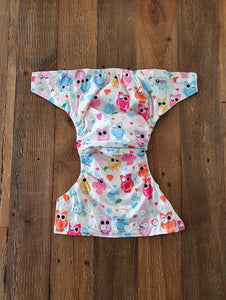 Beautiful soft pastel coloured owls on a silky white nappy, with charcoal grey inner.