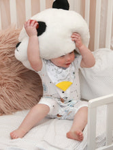Load image into Gallery viewer, Baby sits with stuffed panda mascot head above her face, in stunning blue, beige and black onesie with Bamboo Babywear bib over the top with yellow teeth tip.