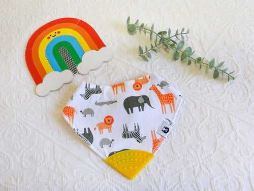Jungle favourites lion, giraffe, zebra and elephant in greys and burnt orange tones on a white bib, with a yellow teething tip.