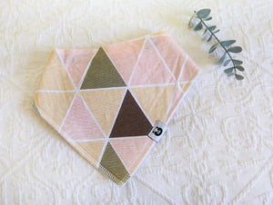 Lovely pink, beige and yellow geometric patterned bib.