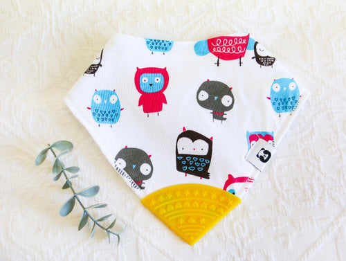 Gothic cartoon owls in black, blue and burgundy, on a white bib with a yellow teething tip.