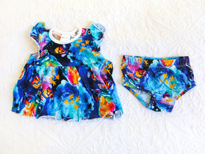 Bold and beautiful watercolour style romper, consisting of a dress and matching knickers. In shades of indigo, turquiose and midnight blue, with hot pink and sunny orange fireflies in jars.
