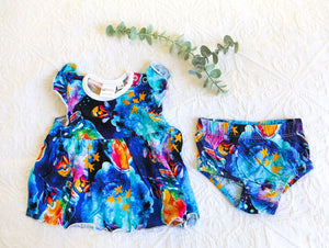 Bold and beautiful watercolour style romper, consisting of a dress and matching knickers. In shades of indigo, turquiose and midnight blue, with hot pink and sunny orange fireflies in jars.