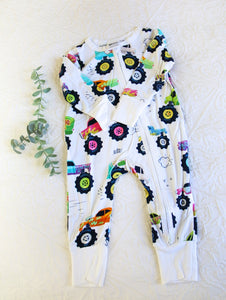 Bright and funky multi-coloured monster trucks on white background, long sleeved onesie.