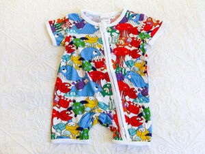 Vibrant and colourful short sleeve onesie with a host of fish and sea creatures, in a splash of attention grabbing colours including res, blue, yellow, green and purple.