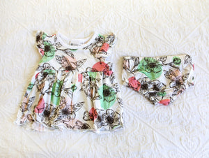 Romper dress with matching knickers in a stunning floral pattern with mint green and baby pink accents.