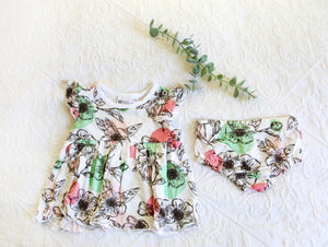 Romper dress with matching knickers in a stunning floral pattern with mint green and baby pink accents.