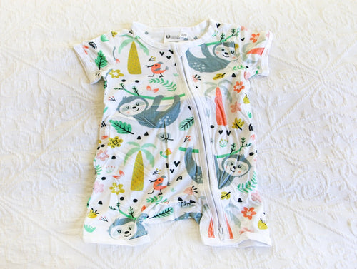 A calming and soft sloth with some brighter trees and tones, on a white short sleeved onesie. 