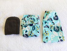 Load image into Gallery viewer, Alt Text: An aqua coloured nappy with navy blue and white birds, trees and acorns. 