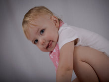 Load image into Gallery viewer, Baby knelt down with side view of pink and white, Cupids Heart Bib