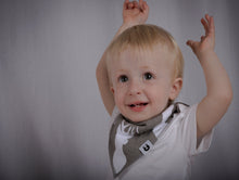 Load image into Gallery viewer, Grey bib with white stag face, sits snug on toddler raising their arms in happiness.
